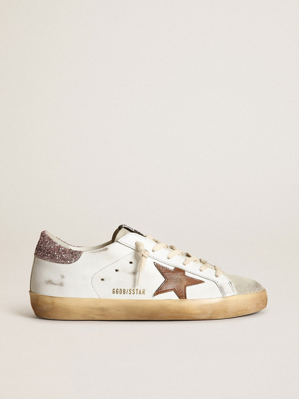 Golden Goose Super-Star with a tan star and pink glitter heel tab