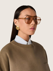Golden Goose Aviator style sunglasses with honey-colored frame and lenses