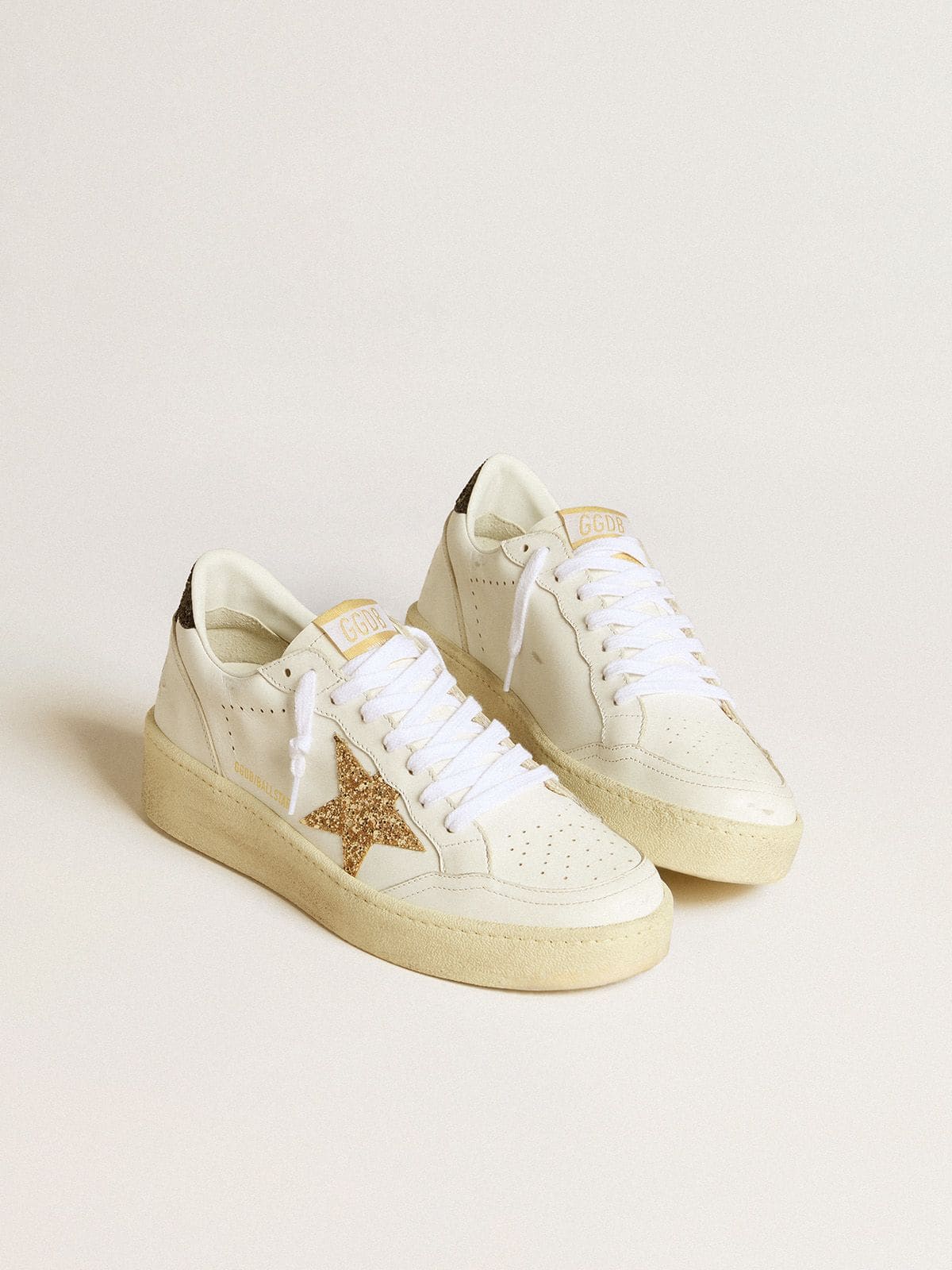 Golden Goose Women’s Ball Star in white leather with gold glitter star and black glitter heel tab