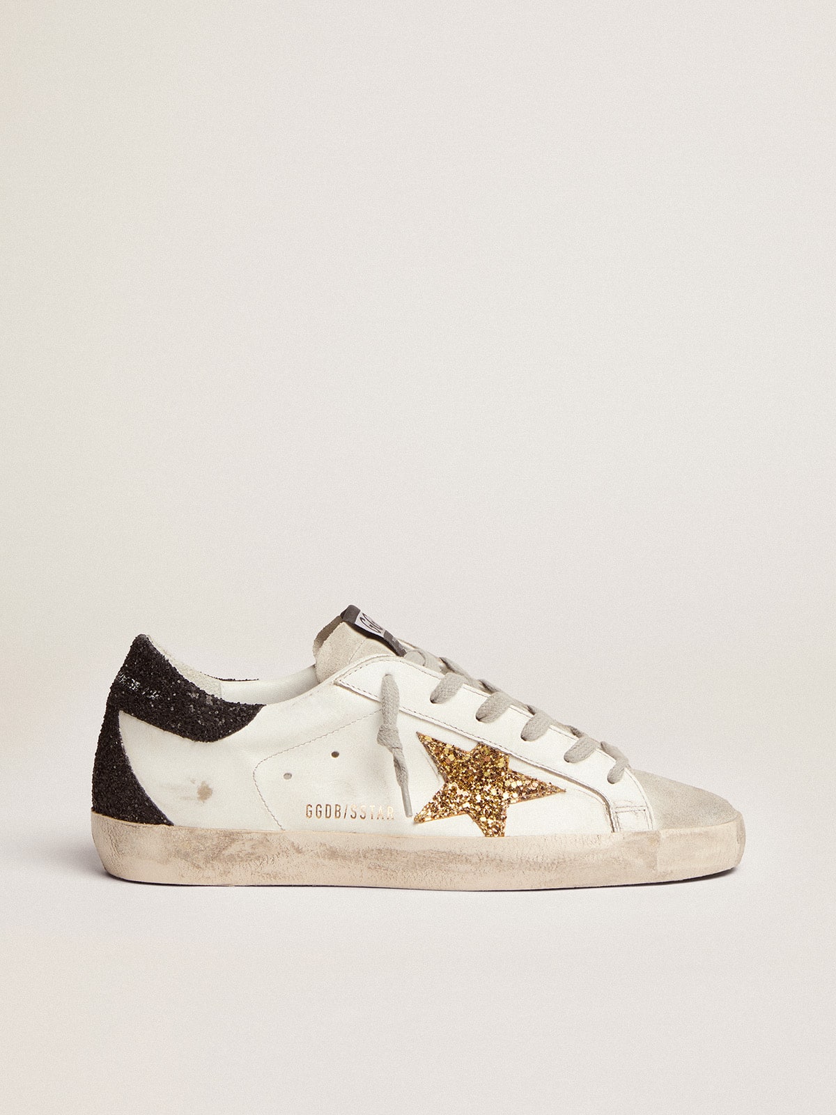 Golden Goose Women’s Super-Star in nappa leather with gold glitter star and black glitter heel tab