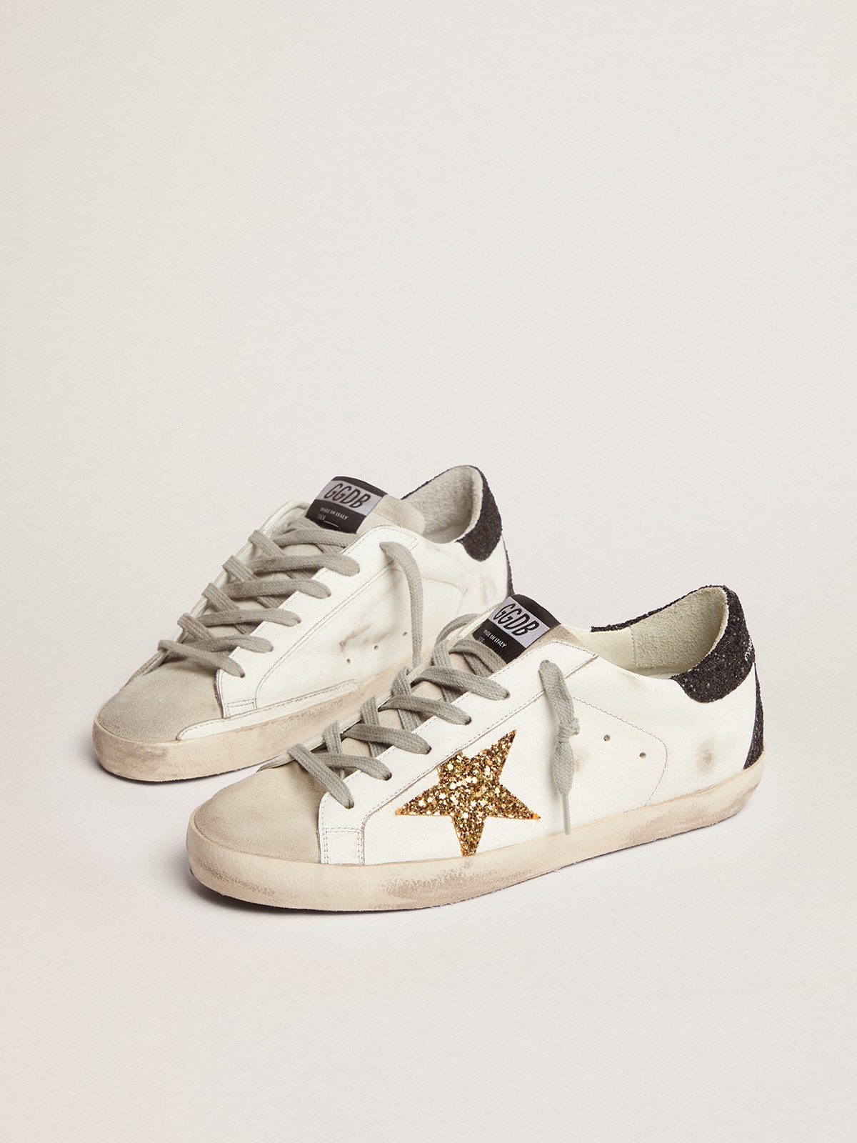 Golden Goose Women’s Super-Star in nappa leather with gold glitter star and black glitter heel tab