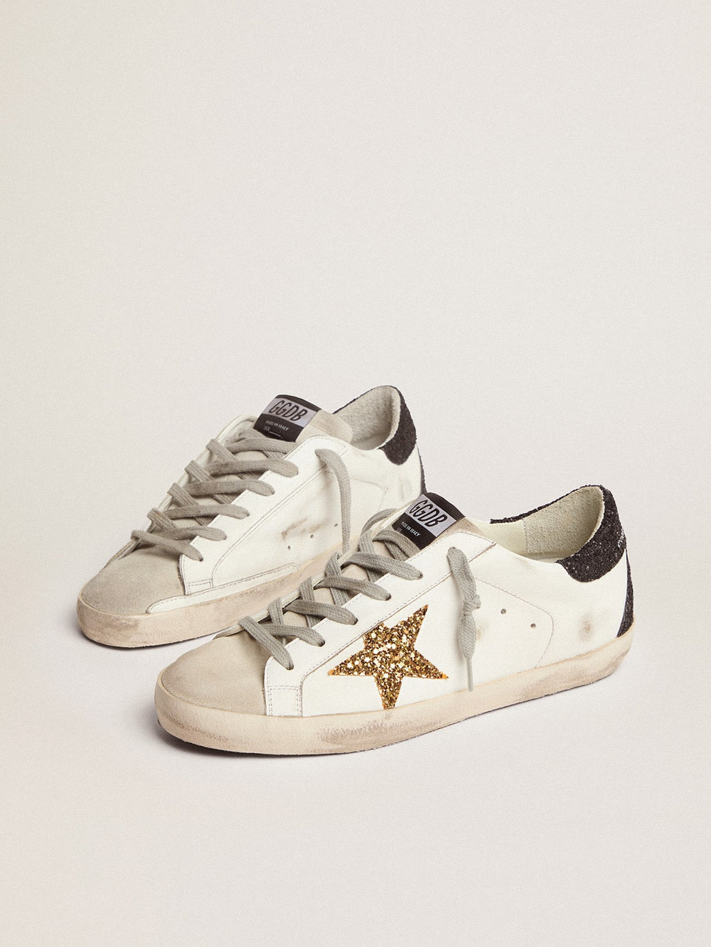 Golden Goose Women’s Super-Star in nappa leather with gold glitter star and black glitter heel tab