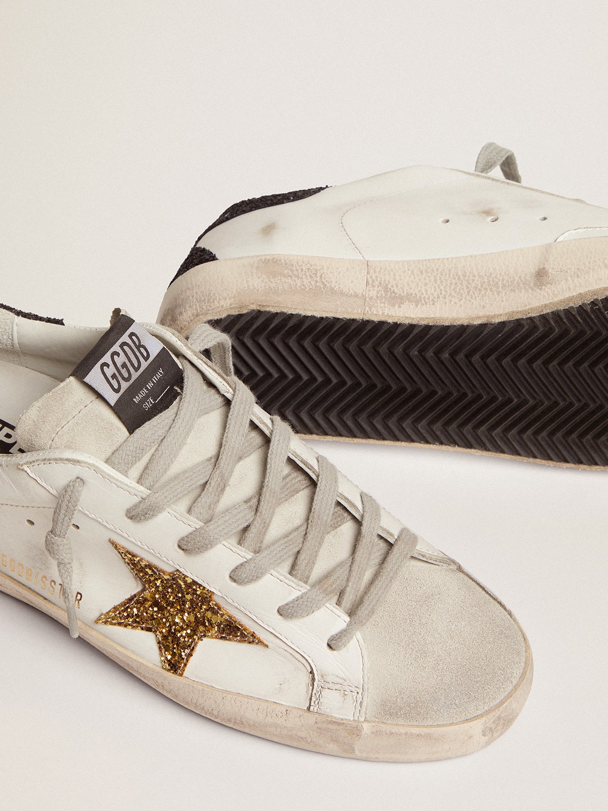Golden Goose Women’s Super-Star in nappa leather with gold glitter star and black glitter heel tab