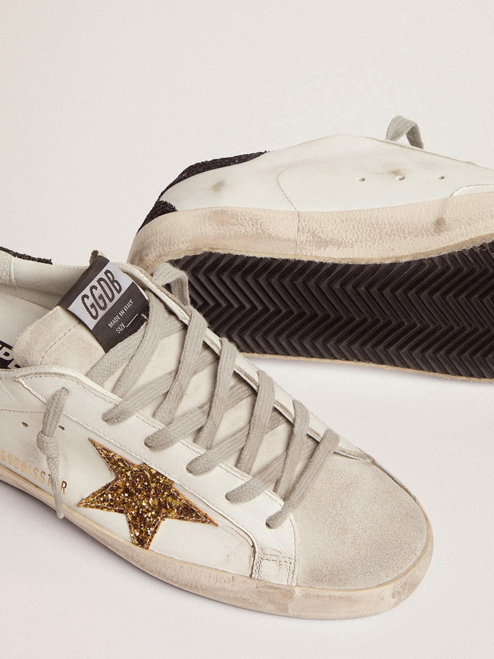 Golden Goose Women’s Super-Star in nappa leather with gold glitter star and black glitter heel tab