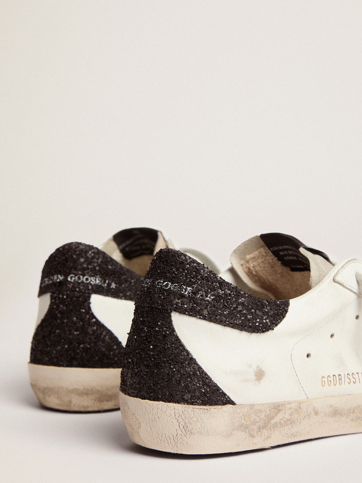 Golden Goose Women’s Super-Star in nappa leather with gold glitter star and black glitter heel tab