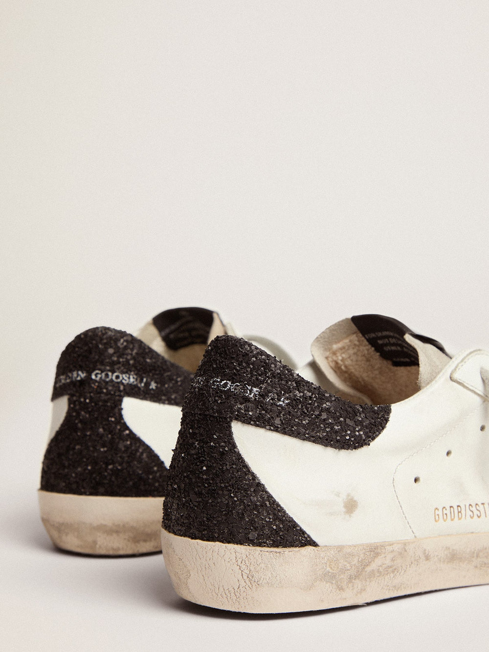 Golden Goose Women’s Super-Star in nappa leather with gold glitter star and black glitter heel tab