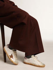 Golden Goose Super-Star with a tan star and pink glitter heel tab