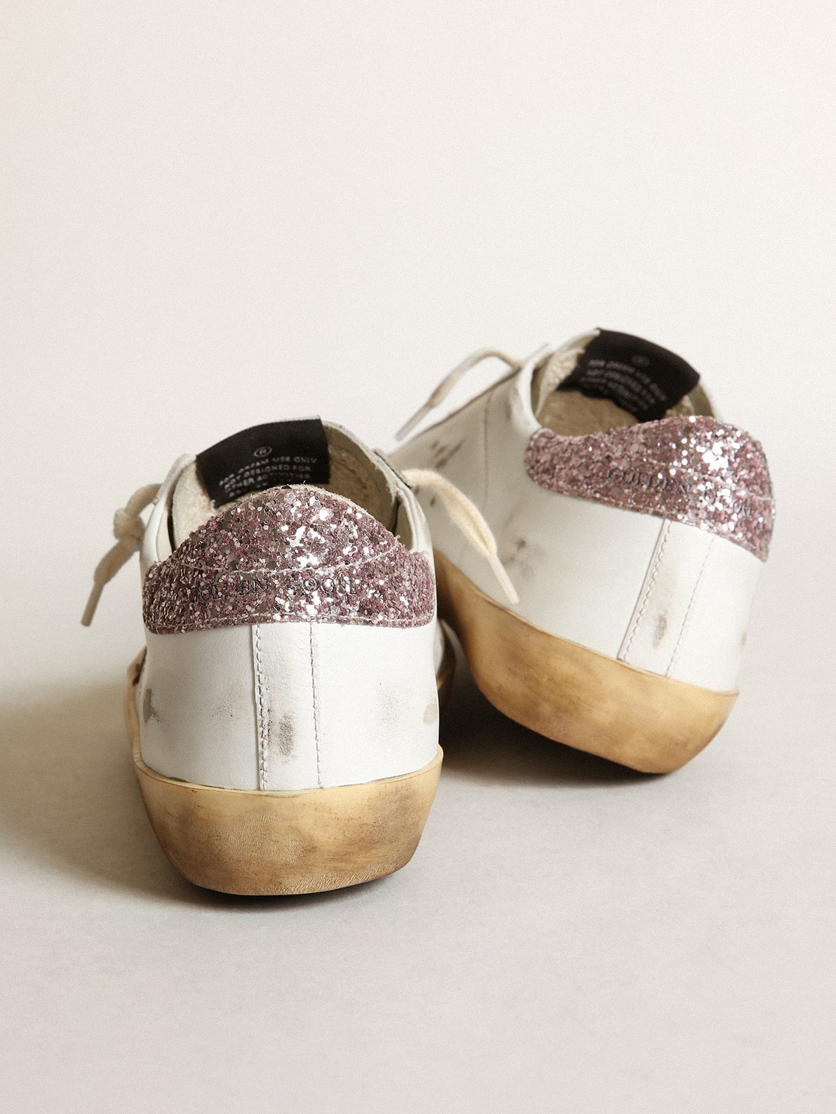 Golden Goose Super-Star with a tan star and pink glitter heel tab