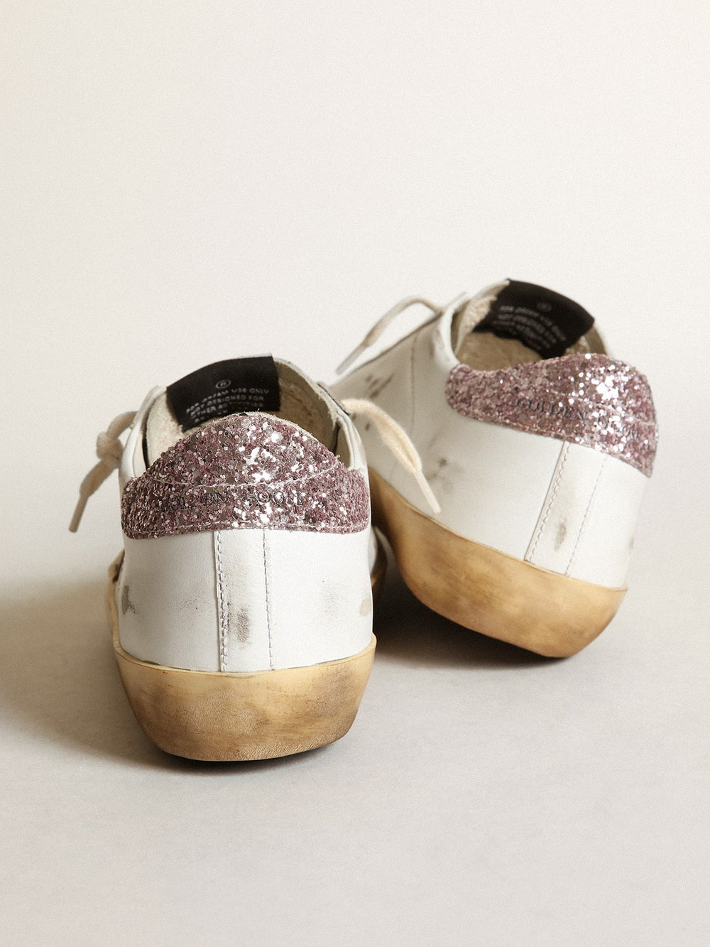 Golden Goose Super-Star with a tan star and pink glitter heel tab