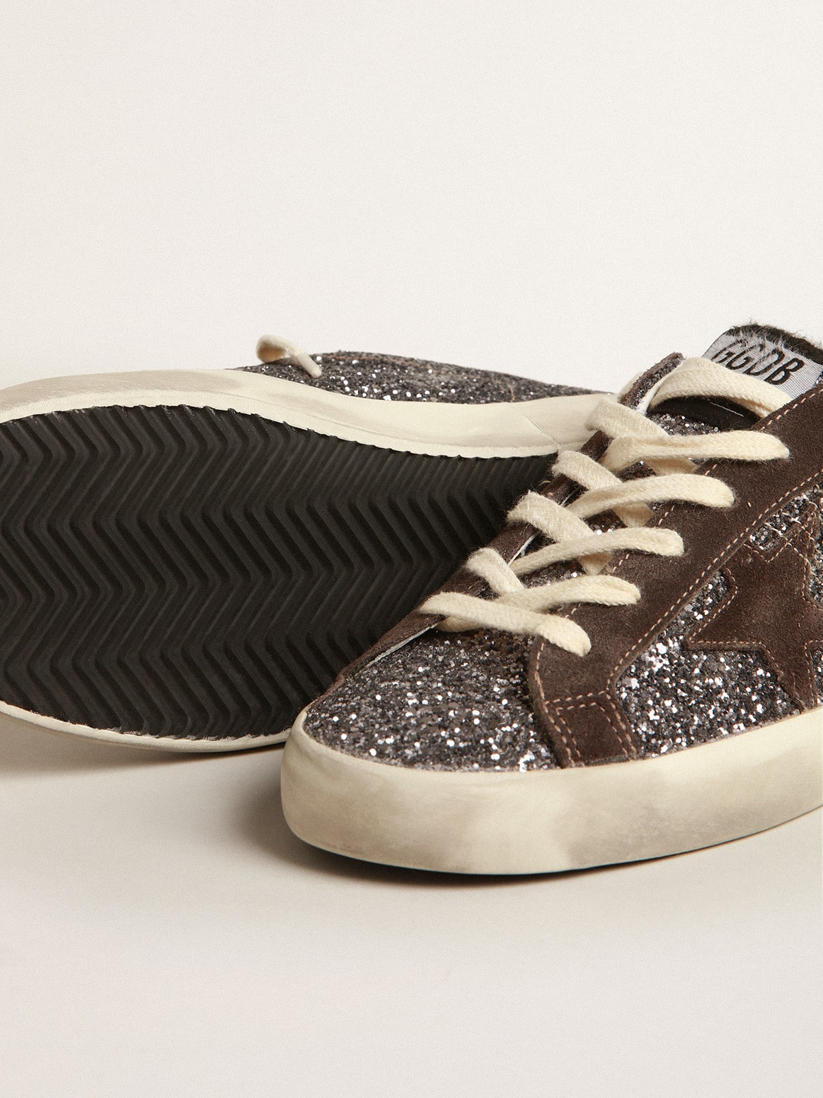 Golden Goose Super-Star in glitter with a brown star and lilac heel tab