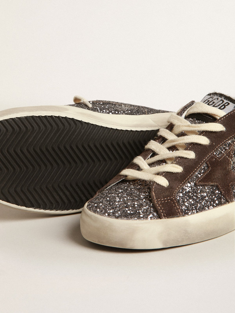 Golden Goose Super-Star in glitter with a brown star and lilac heel tab