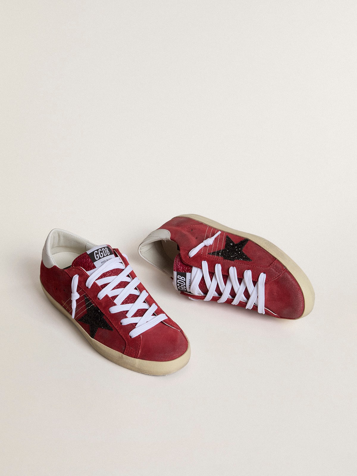 Golden Goose Women’s Super-Star in red suede with glitter star and white heel tab