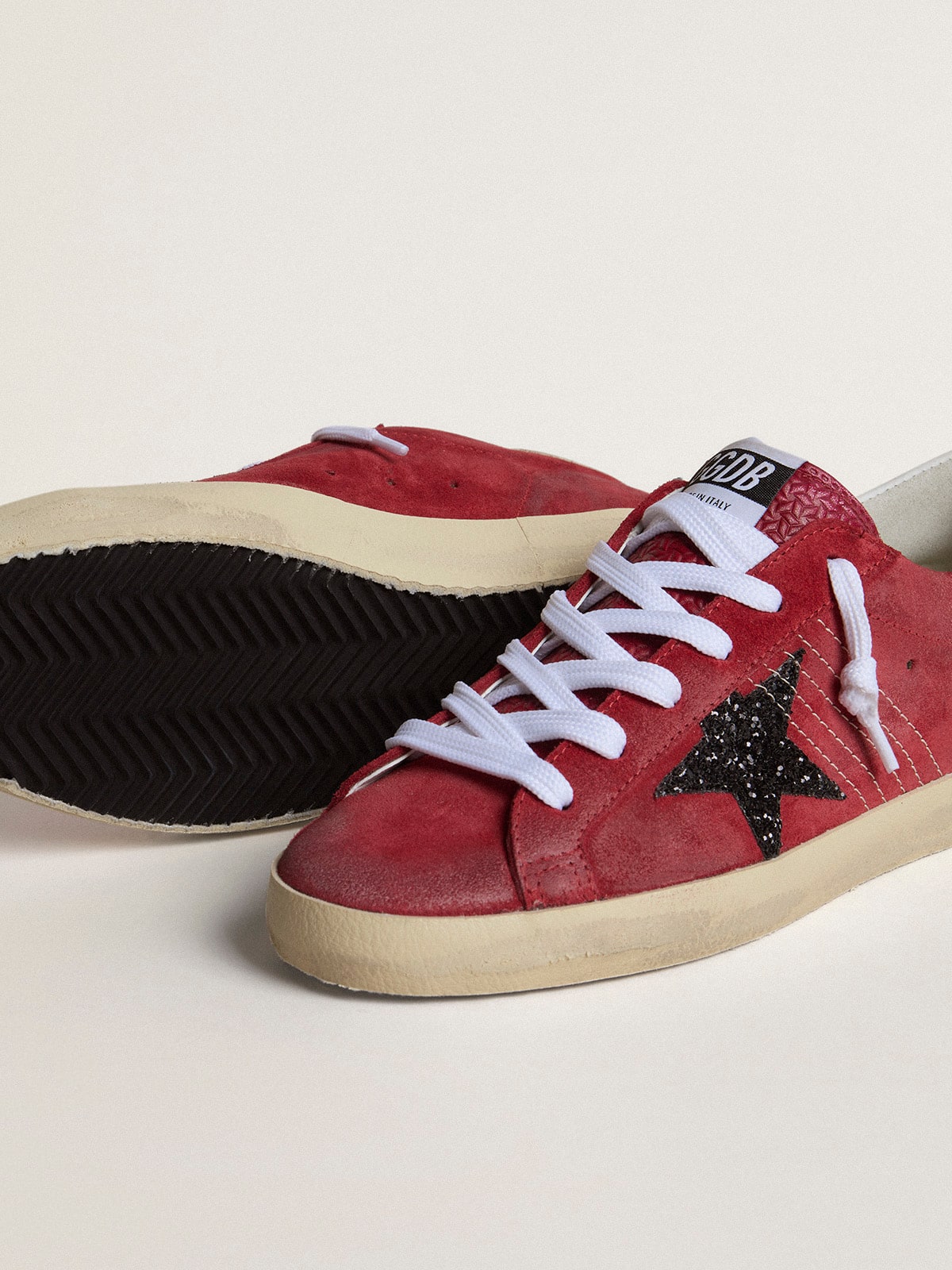 Golden Goose Women’s Super-Star in red suede with glitter star and white heel tab