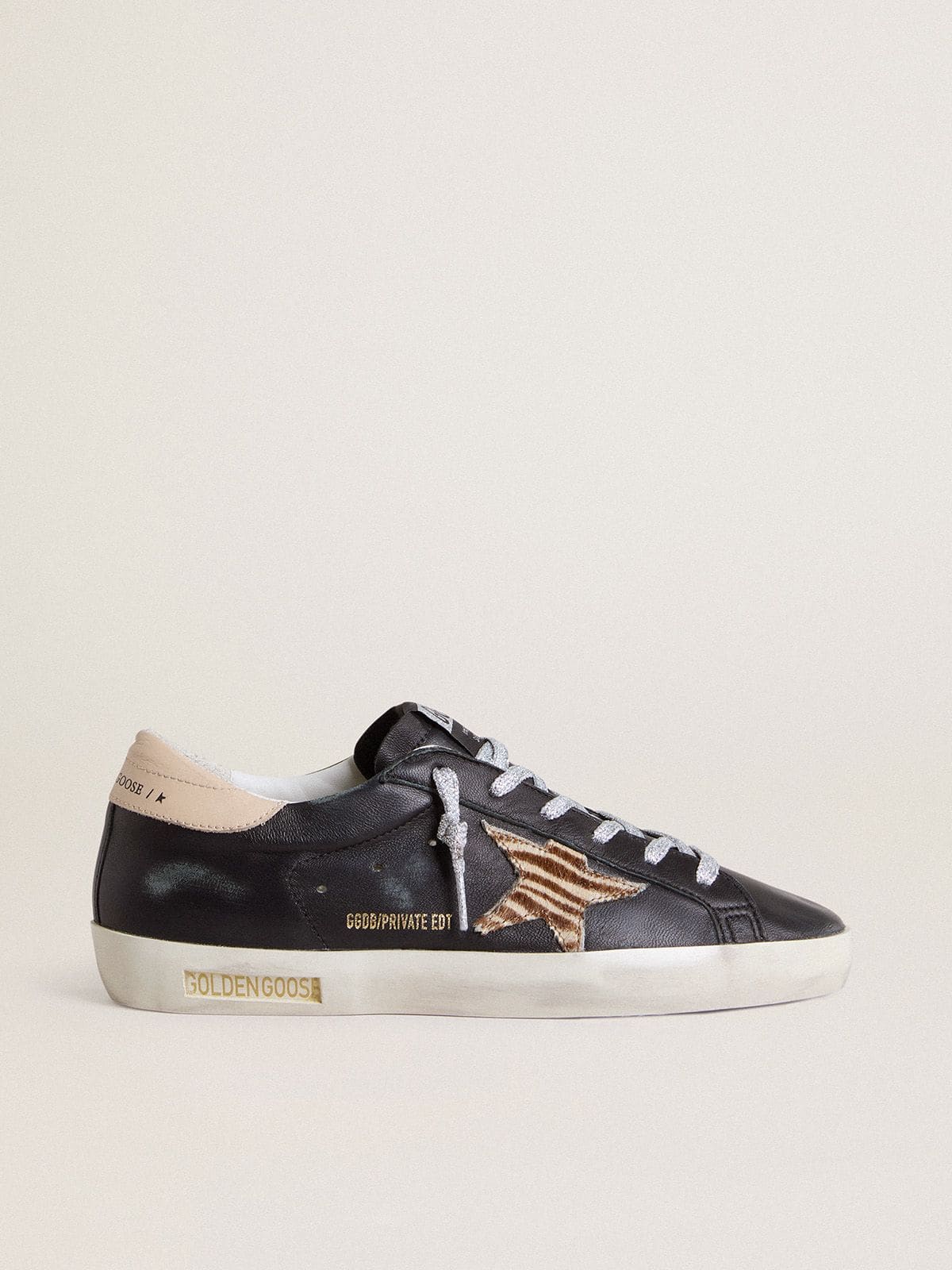 Golden Goose Women’s Super-Star in black nappa leather with zebra-print pony skin star and beige leather heel tab