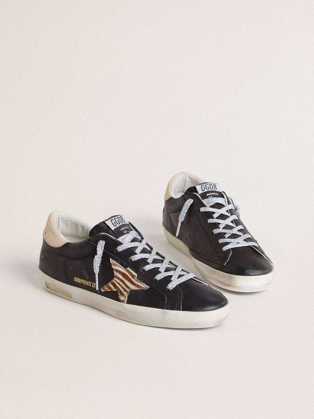 Golden Goose Women’s Super-Star in black nappa leather with zebra-print pony skin star and beige leather heel tab