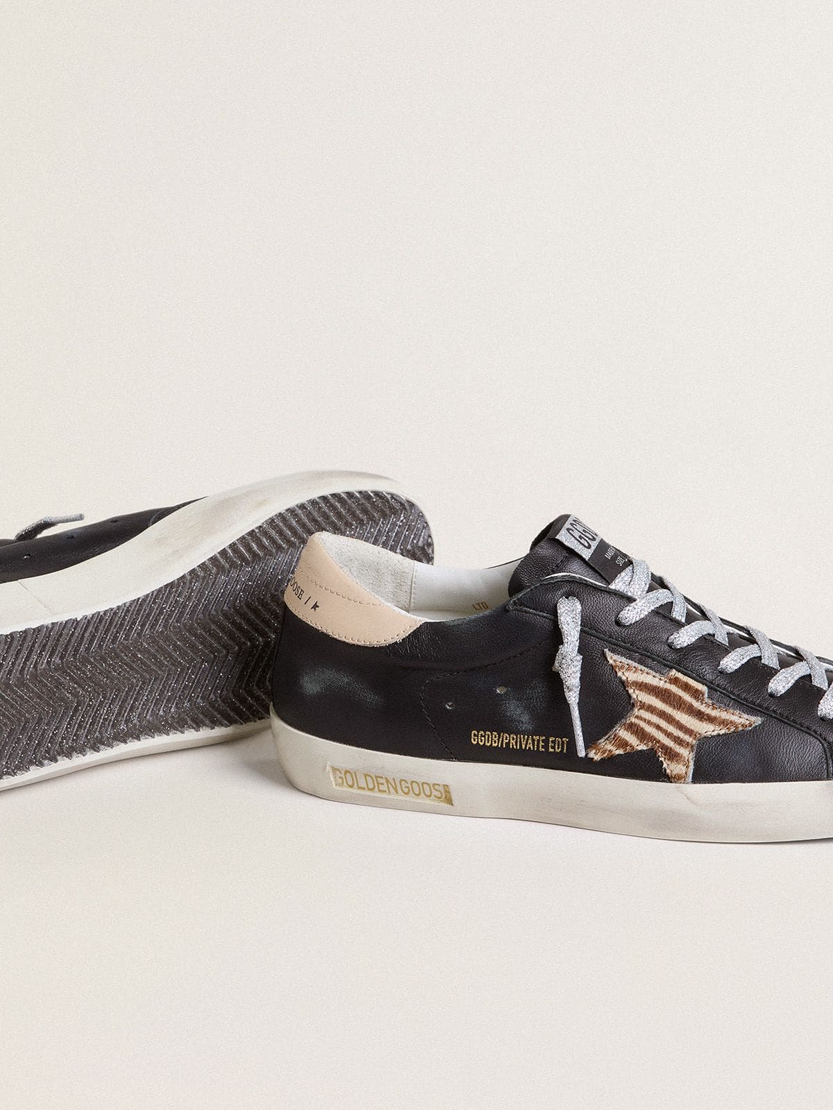 Golden Goose Women’s Super-Star in black nappa leather with zebra-print pony skin star and beige leather heel tab