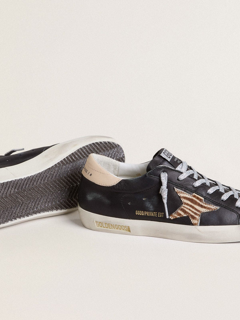 Golden Goose Women’s Super-Star in black nappa leather with zebra-print pony skin star and beige leather heel tab