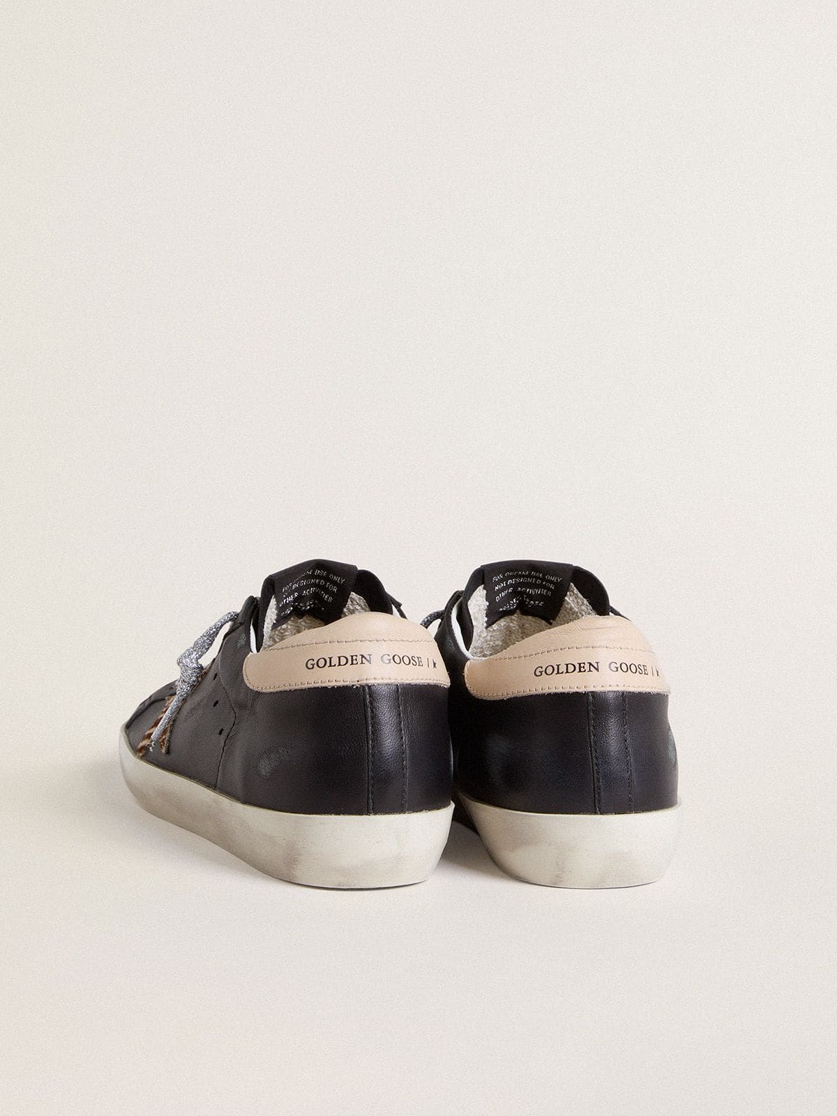 Golden Goose Women’s Super-Star in black nappa leather with zebra-print pony skin star and beige leather heel tab
