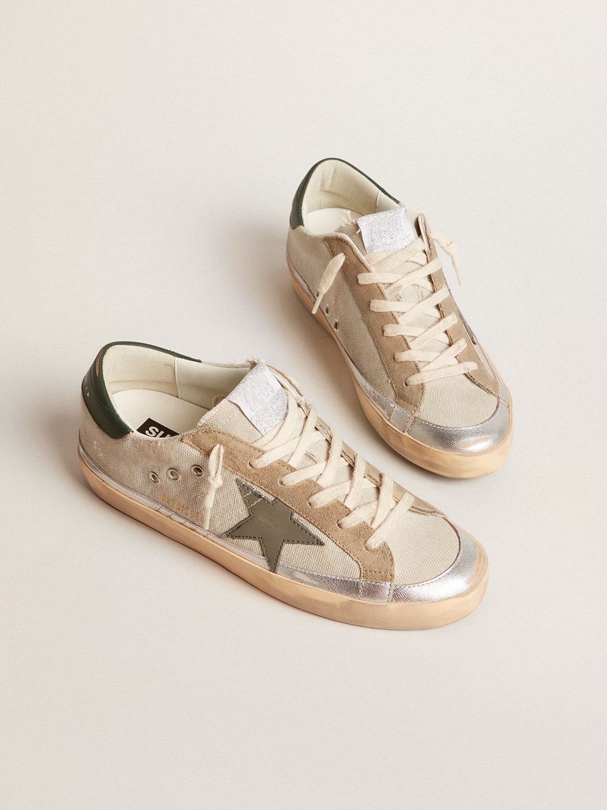 Golden Goose Super-Star in gray canvas with a green leather star and heel tab