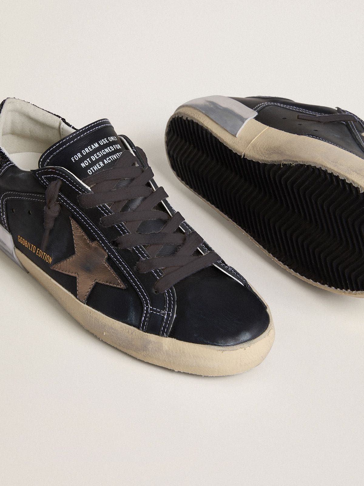 Golden Goose Women's Super-Star LTD in black leather with gold leather star and black glitter heel tab