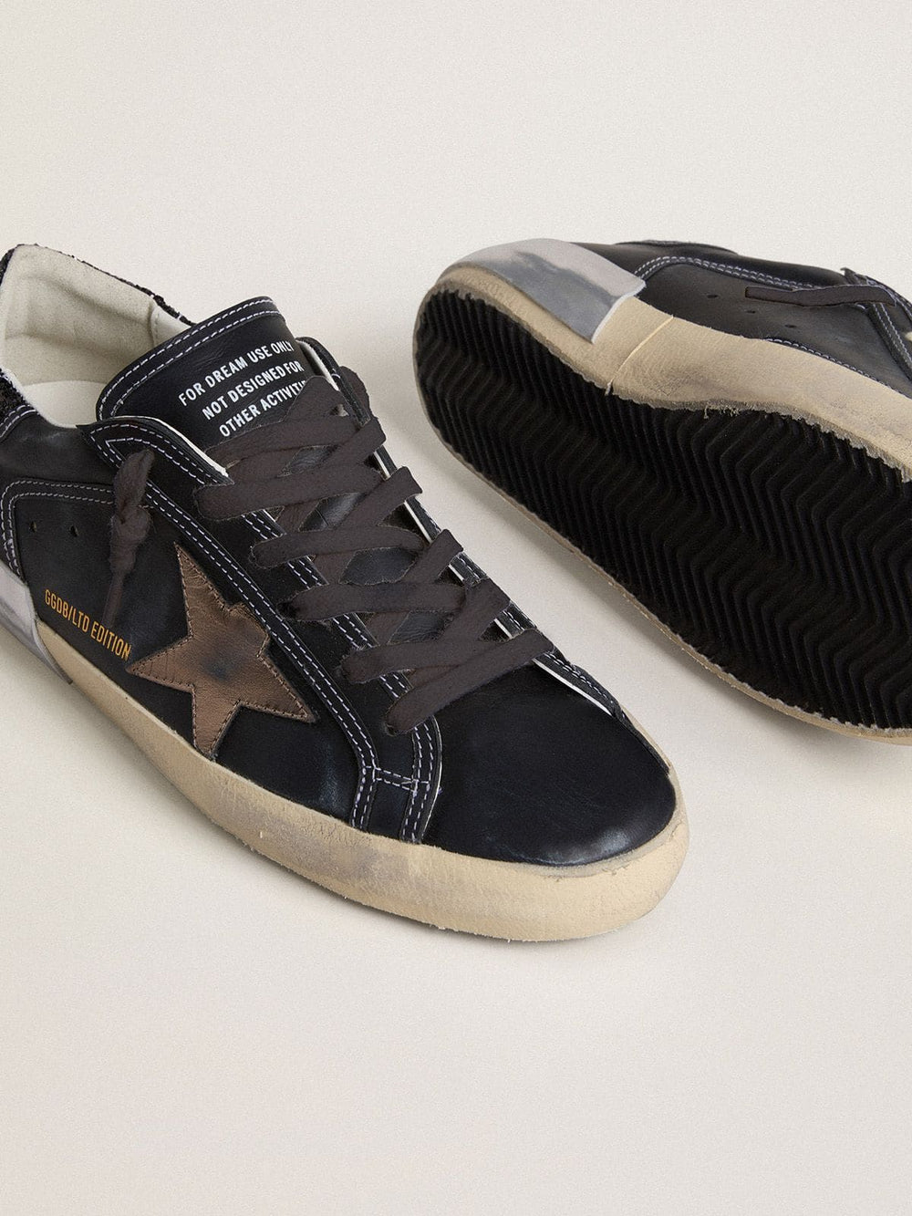 Golden Goose Women's Super-Star LTD in black leather with gold leather star and black glitter heel tab