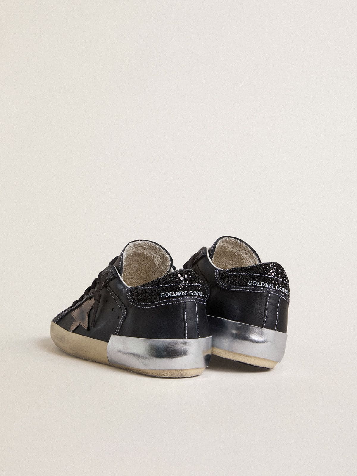 Golden Goose Women's Super-Star LTD in black leather with gold leather star and black glitter heel tab