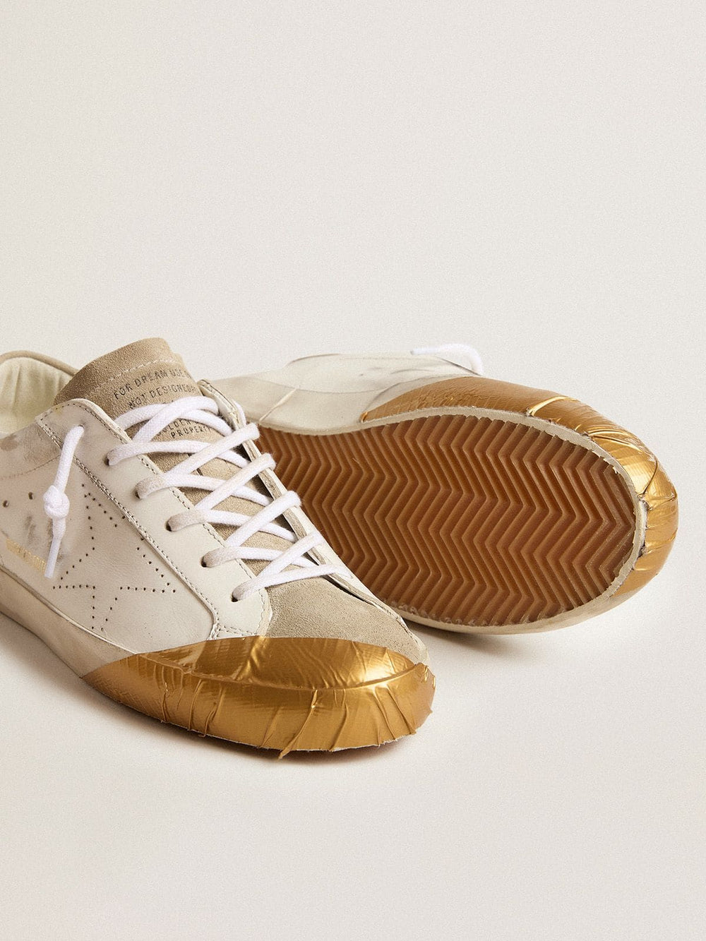 Golden Goose Women's Super-Star LTD in white leather with ice-gray suede inserts and gold-colored tape