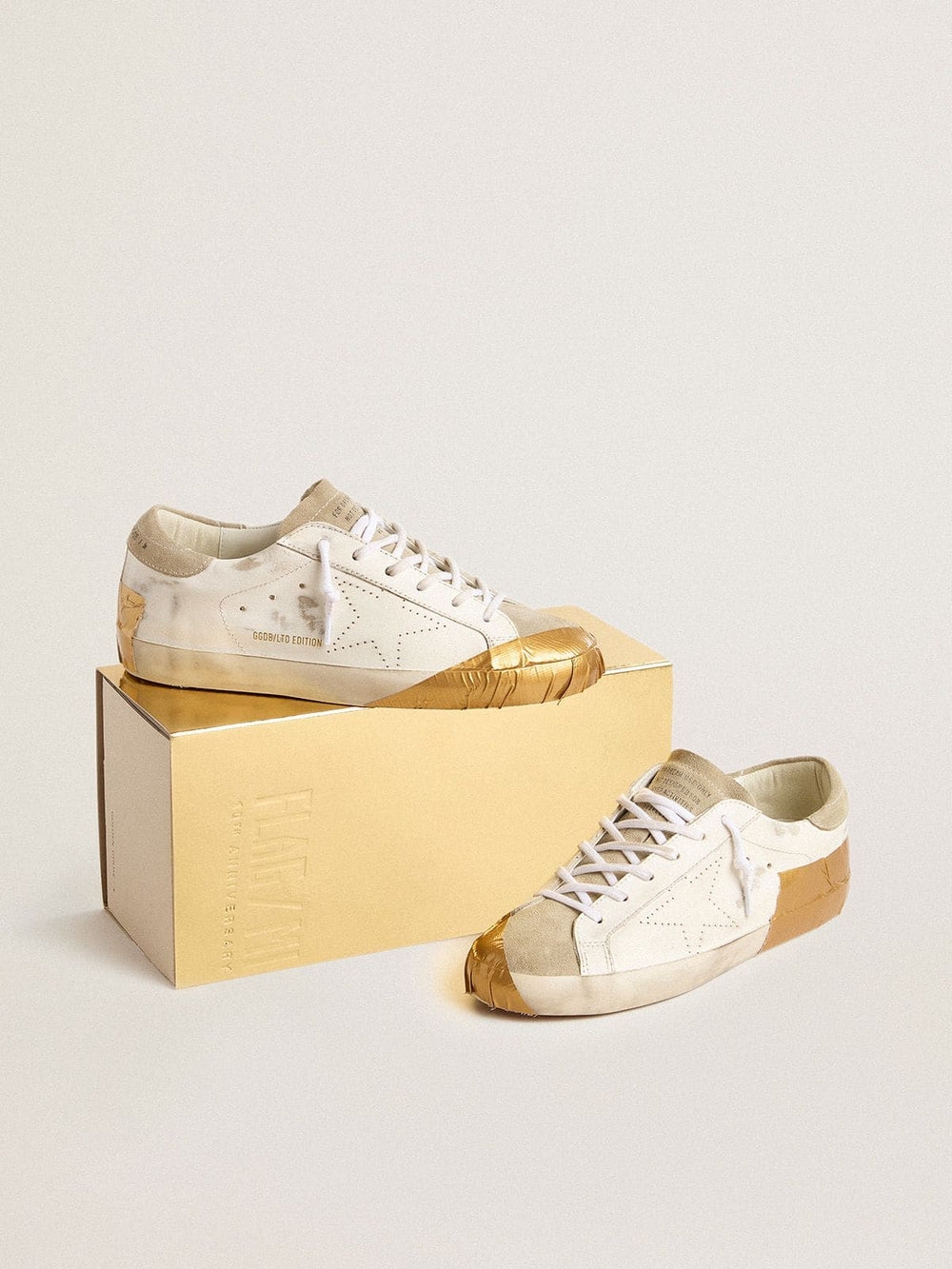 Golden Goose Women's Super-Star LTD in white leather with ice-gray suede inserts and gold-colored tape