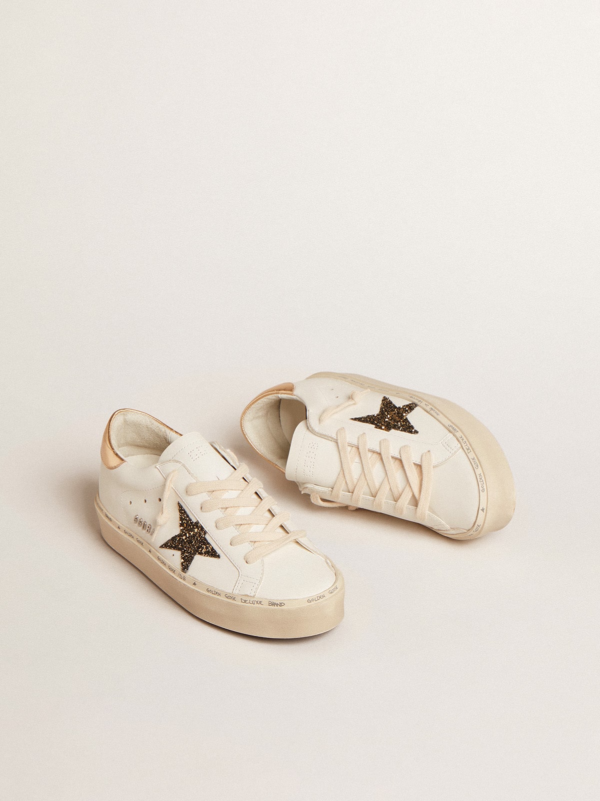 Golden Goose Hi Star  with black and gold glitter star and gold heel tab