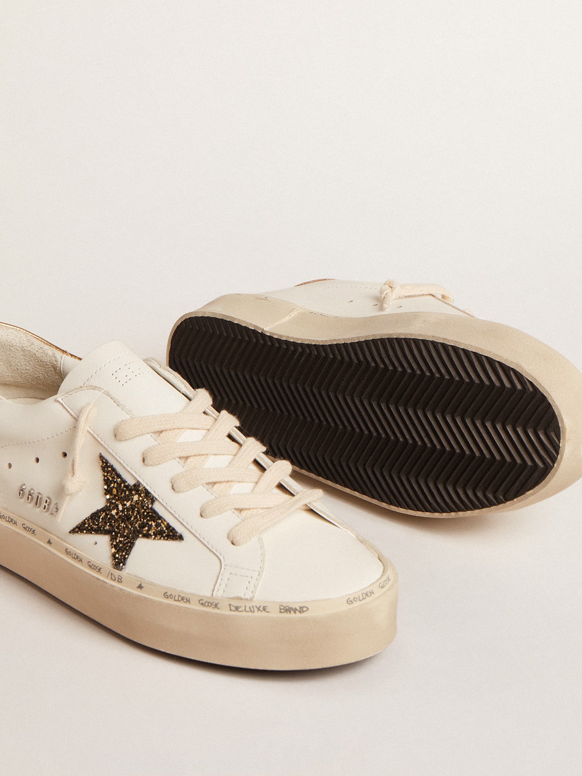 Golden Goose Hi Star  with black and gold glitter star and gold heel tab