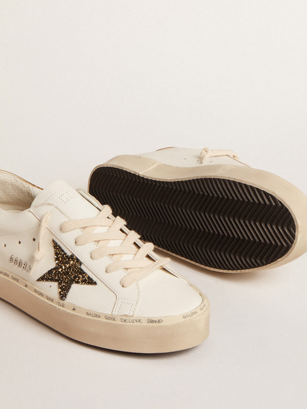 Golden Goose Hi Star  with black and gold glitter star and gold heel tab