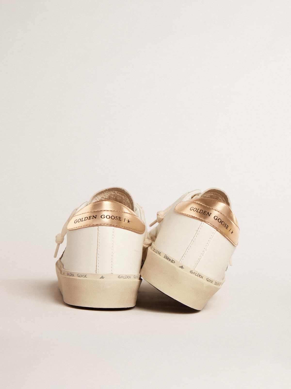 Golden Goose Hi Star  with black and gold glitter star and gold heel tab