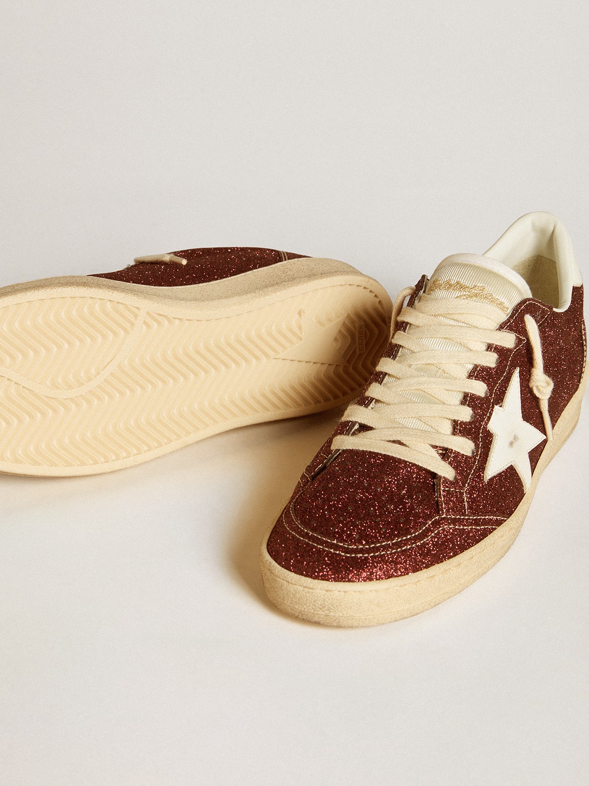 Golden Goose Ball Star in burgundy glitter with white leather star and heel tab
