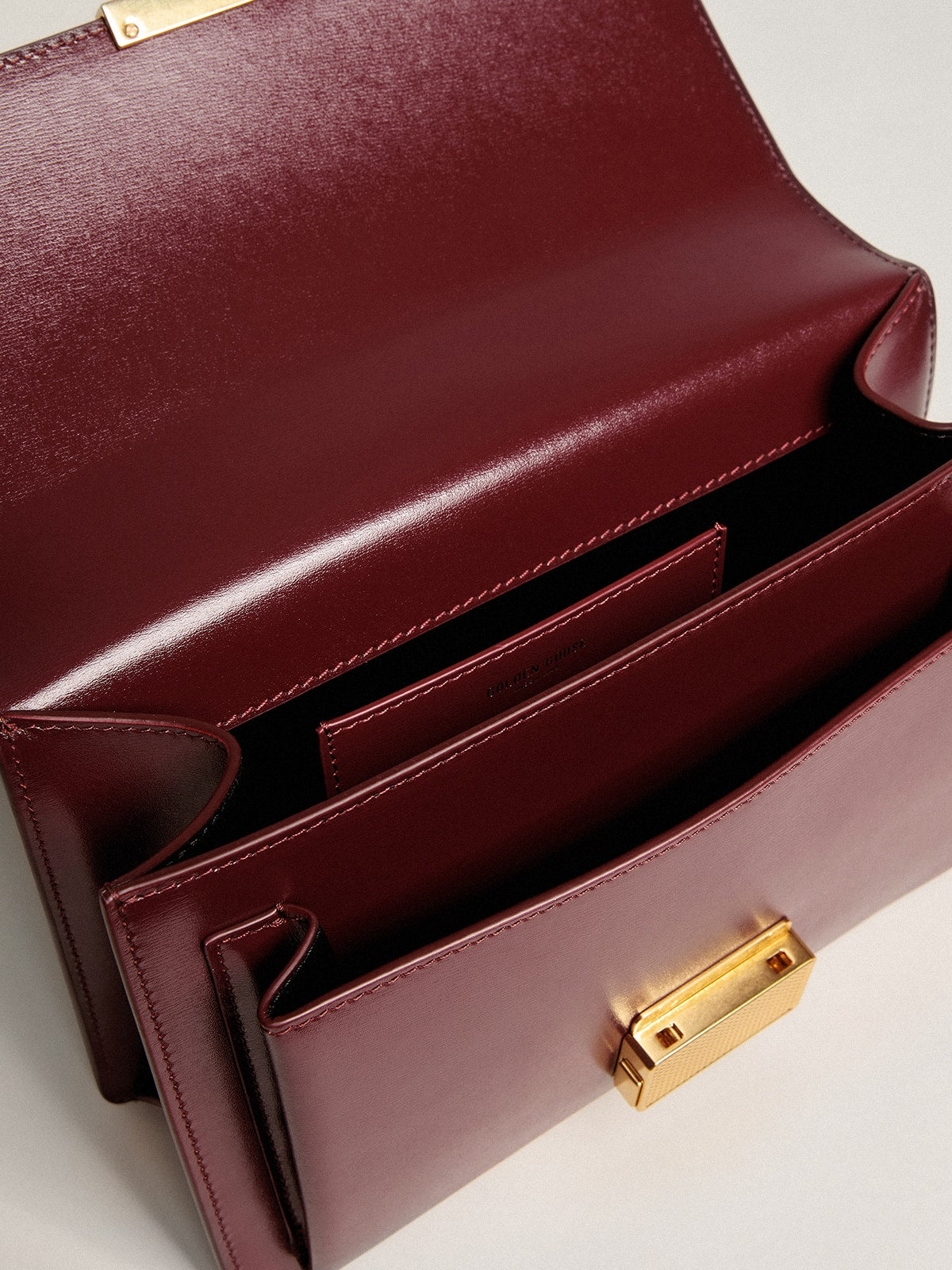 Golden Goose Venezia Bag in burgundy boarded leather with gold details