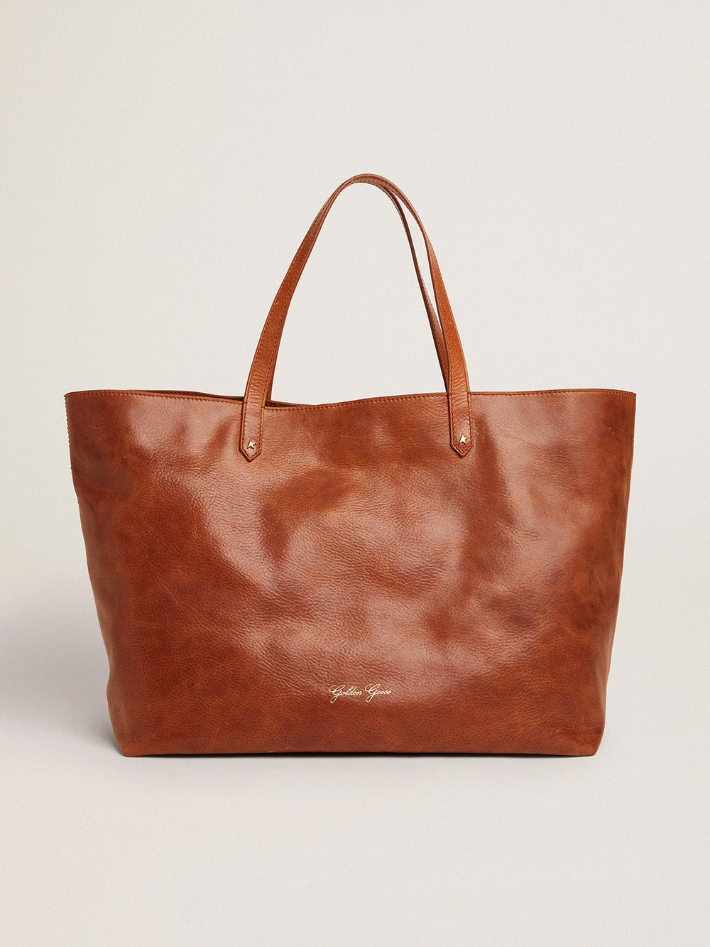 Golden Goose Pasadena Bag in tan-colored glossy hammered leather with gold logo on the front