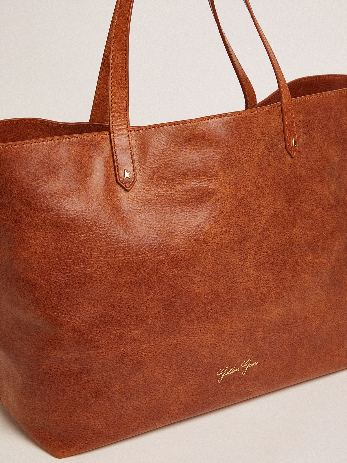 Golden Goose Pasadena Bag in tan-colored glossy hammered leather with gold logo on the front