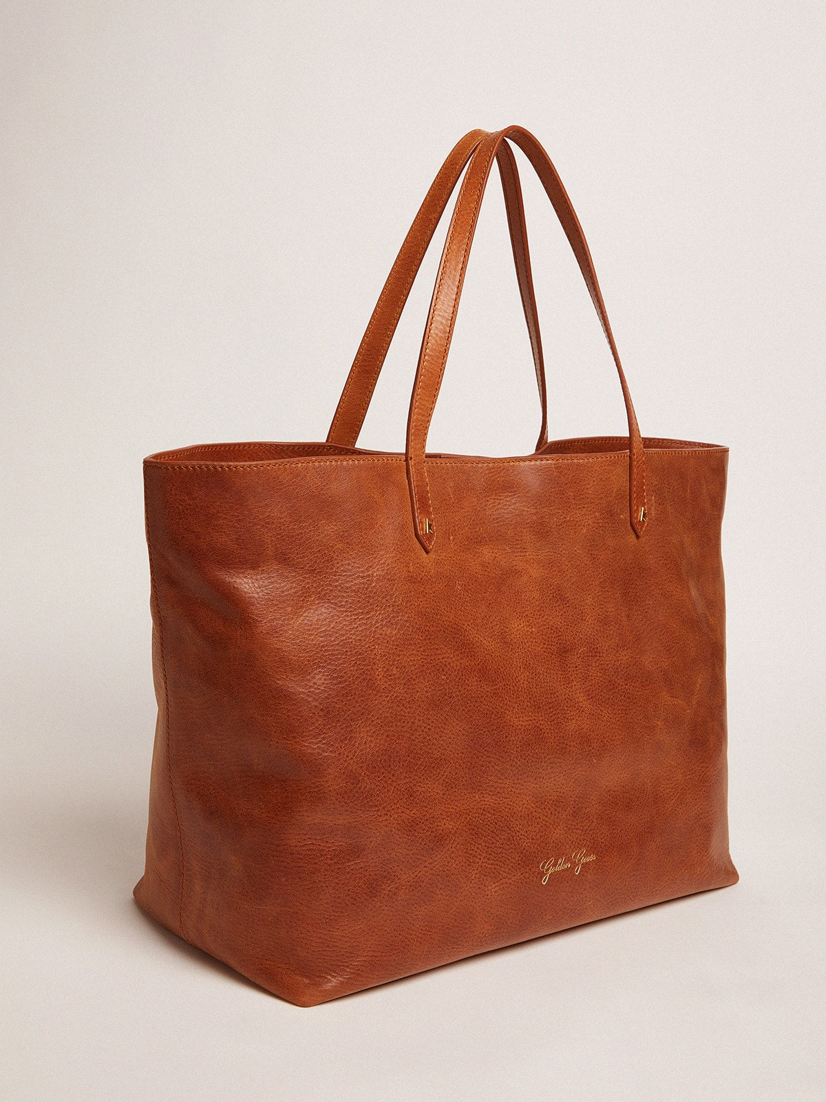 Golden Goose Pasadena Bag in tan-colored glossy hammered leather with gold logo on the front