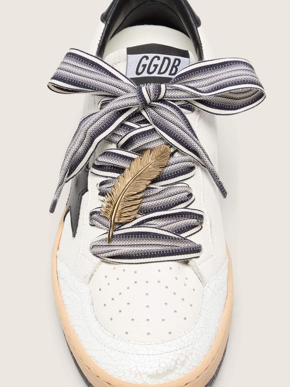 Golden Goose Skins striped laces with gold feather charm
