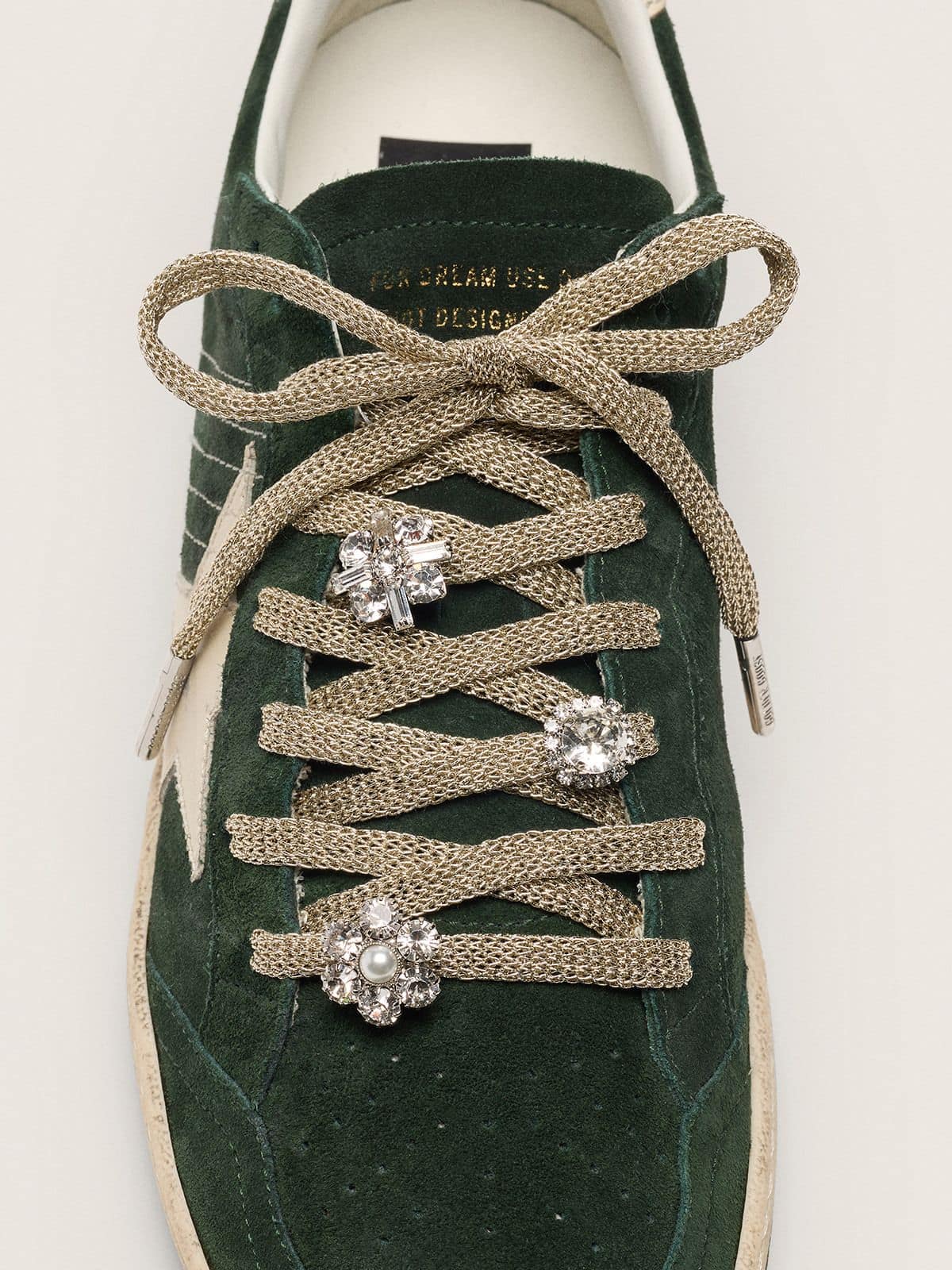 Golden Goose Skins braided gold-colored laces with shimmering charms