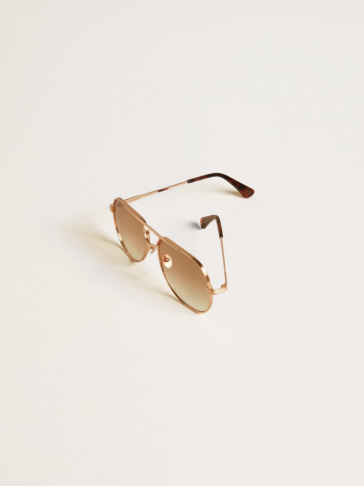 Golden Goose Aviator style sunglasses with rose-gold frame and honey-colored lenses
