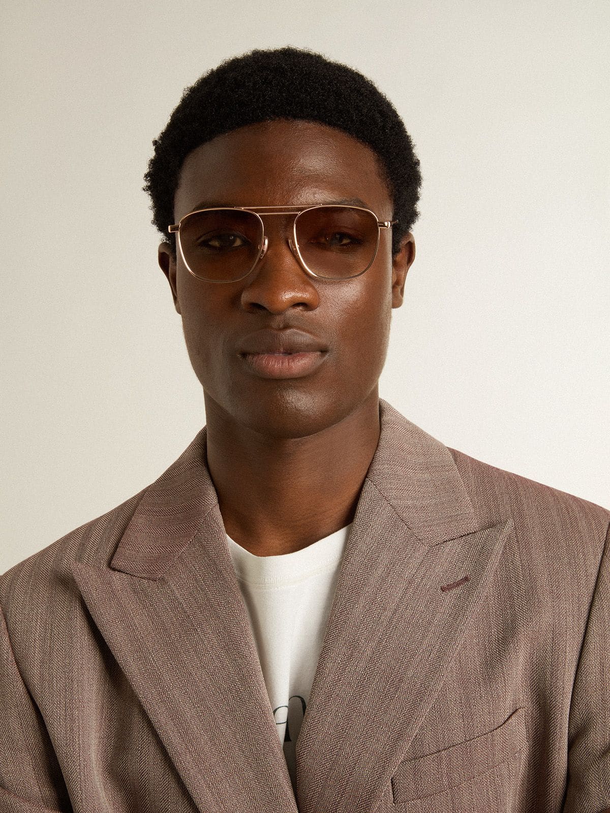 Golden Goose Aviator-style sunglasses with gold frame and beige lenses