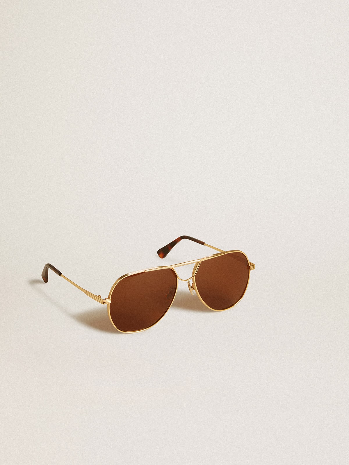 Golden Goose Aviator style sunglasses with gold frame and brown lenses