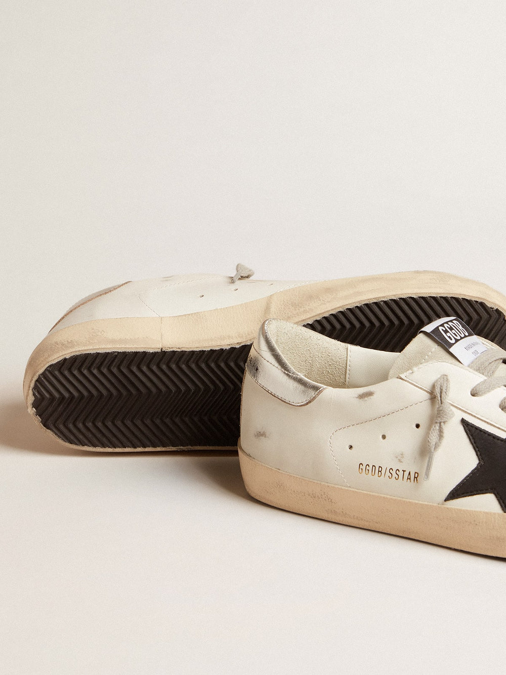 Golden Goose Men's Super-Star in white leather with black nubuck star and silver metallic leather heel tab