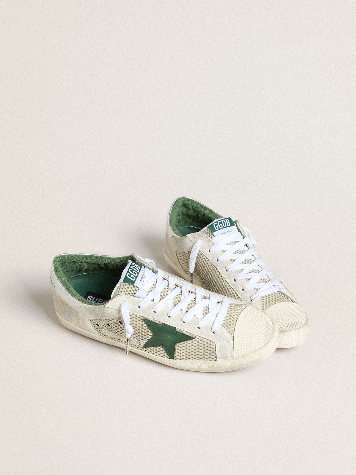 Golden Goose Men’s Super-Star LTD in white suede and mesh with green leather star and silver heel tab