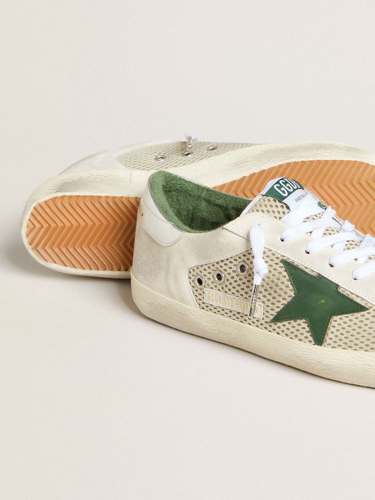 Golden Goose Men’s Super-Star LTD in white suede and mesh with green leather star and silver heel tab