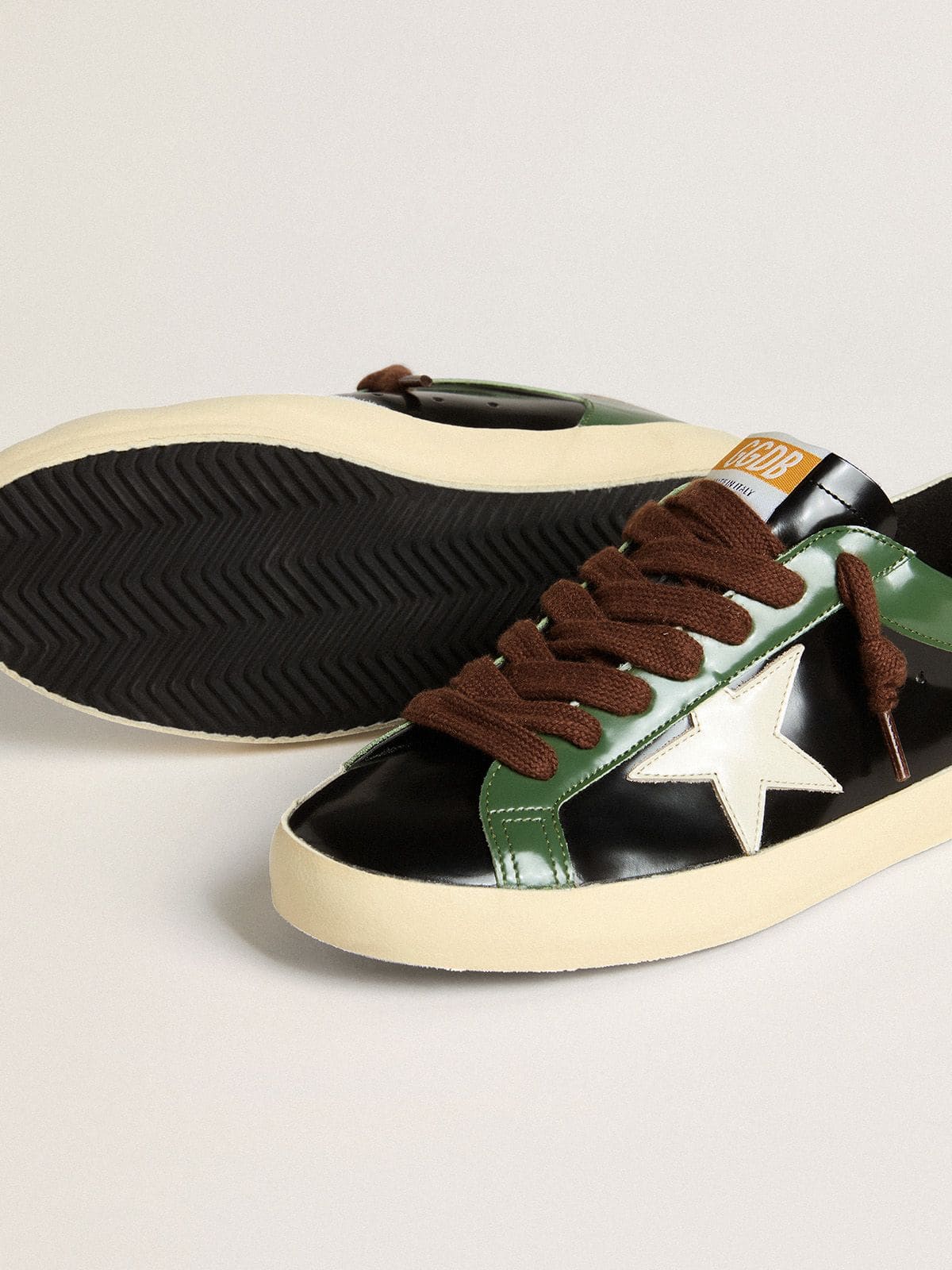 Golden Goose Men’s Super-Star LTD in black laminated leather with white leather star and heel tab