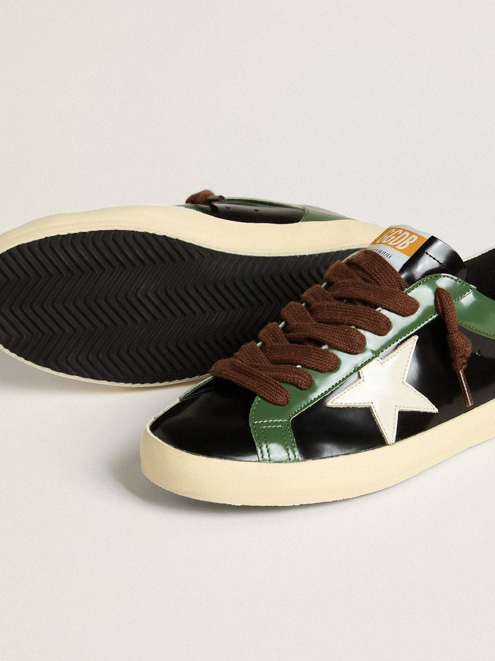 Golden Goose Men’s Super-Star LTD in black laminated leather with white leather star and heel tab