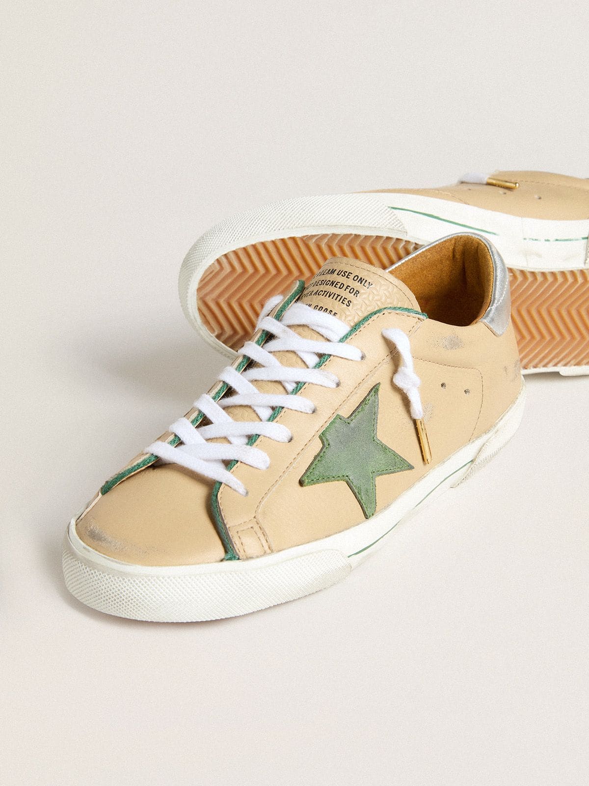 Golden Goose Super-Star LTD in beige leather with green suede star and silver foiled leather heel tab