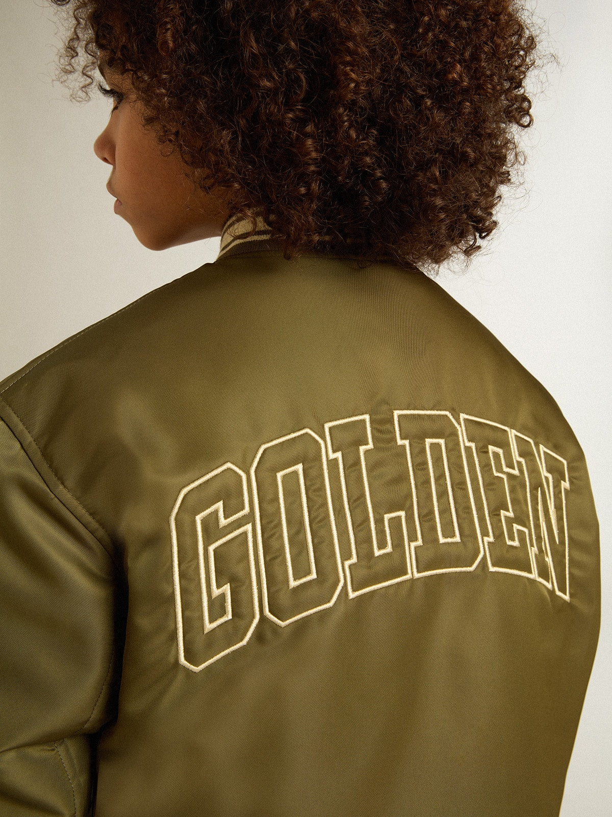 Golden Goose Kids military-green nylon bomber jacket with lettering on the back