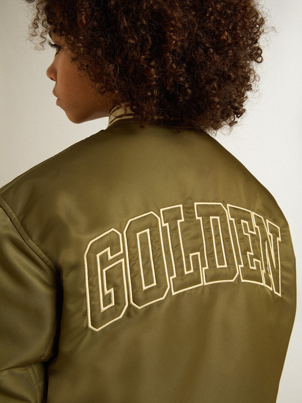 Golden Goose Kids military-green nylon bomber jacket with lettering on the back